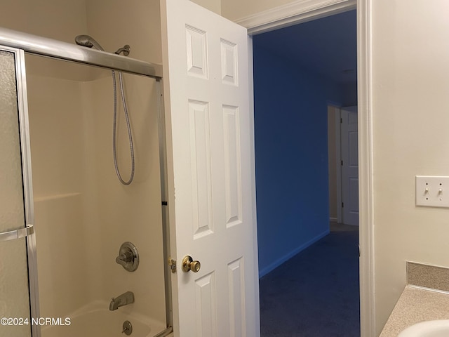 bathroom featuring vanity and shower / bath combination with glass door