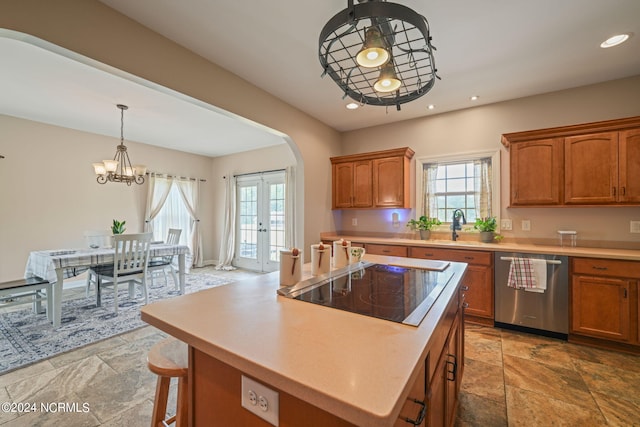 kitchen with french doors, decorative light fixtures, stainless steel dishwasher, a kitchen island, and black electric stovetop