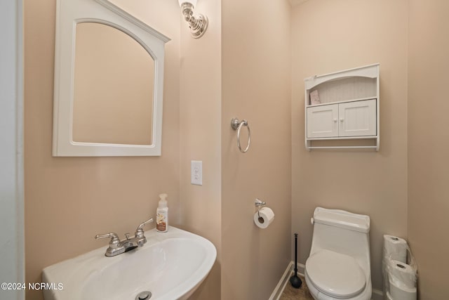 bathroom featuring sink and toilet