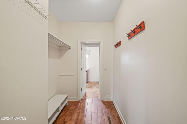 spacious closet with dark hardwood / wood-style flooring