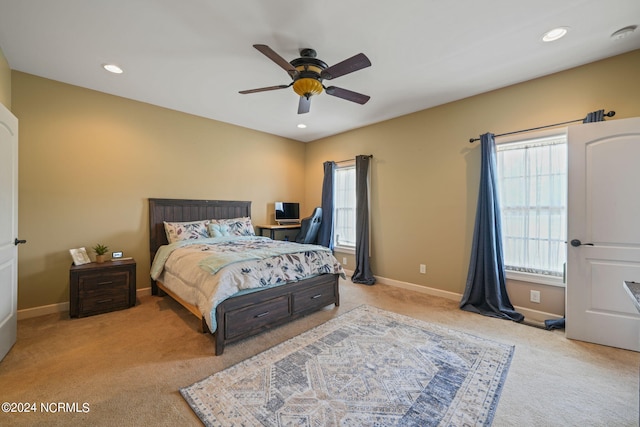 bedroom with light carpet and ceiling fan