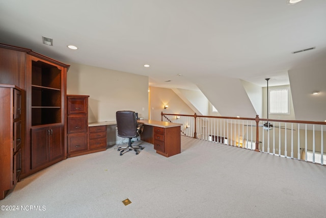 carpeted office featuring vaulted ceiling