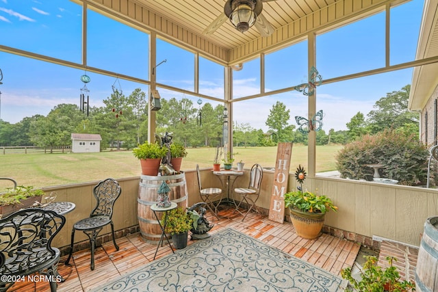 sunroom / solarium with wood ceiling and ceiling fan