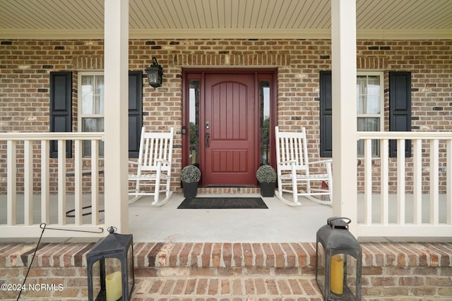 view of exterior entry with covered porch