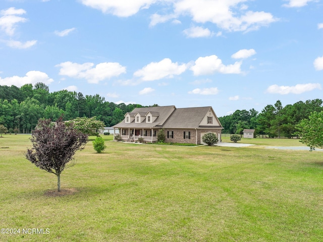 view of front of house with a porch and a front yard