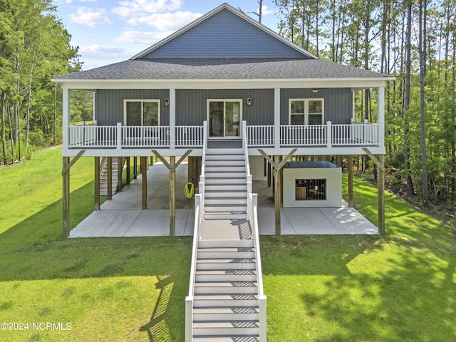 rear view of property with a porch, a patio, and a yard