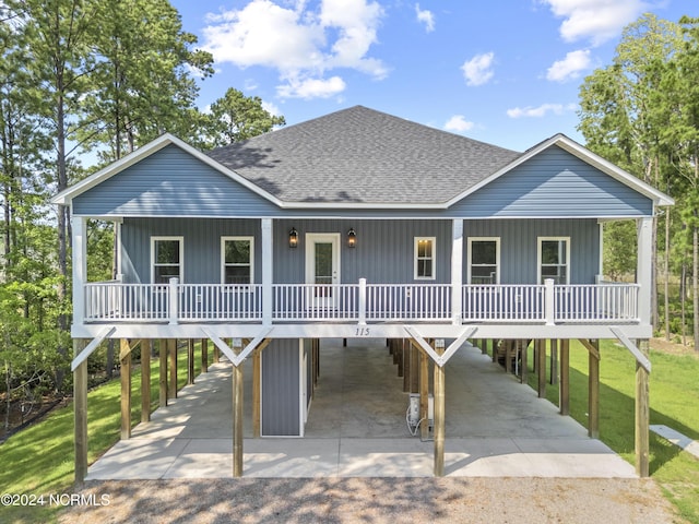 view of front of property featuring a carport, a front yard, and covered porch