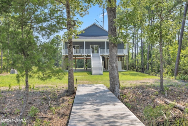 beach home with covered porch and a front lawn