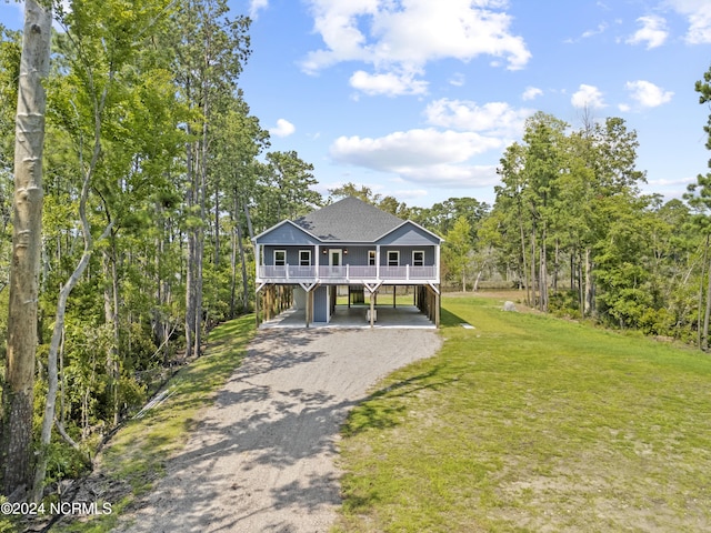 view of front of property with a carport and a front yard