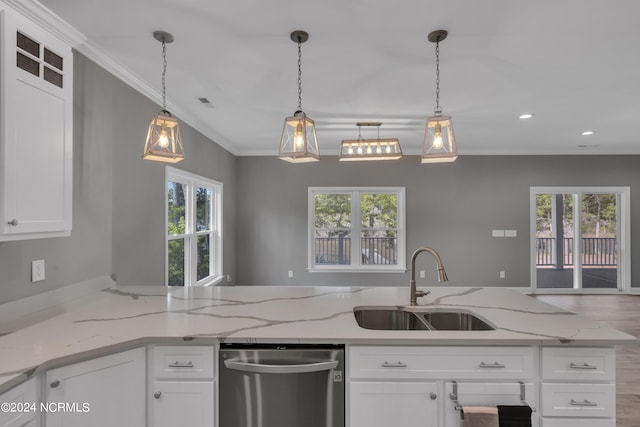 kitchen with light stone countertops, sink, stainless steel dishwasher, and white cabinets