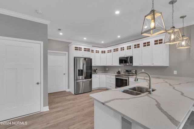 kitchen with pendant lighting, sink, white cabinetry, stainless steel appliances, and light stone counters