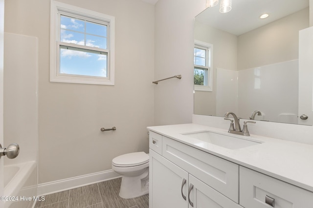 full bathroom featuring vanity,  shower combination, and toilet