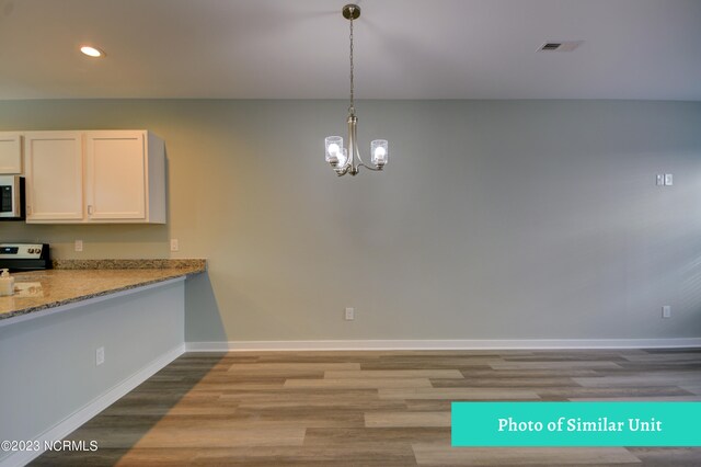 spare room featuring ceiling fan and light wood-type flooring