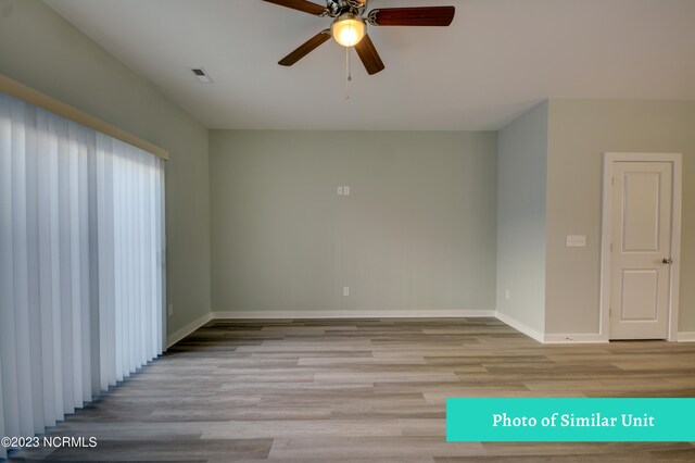 spare room with ceiling fan and hardwood / wood-style flooring