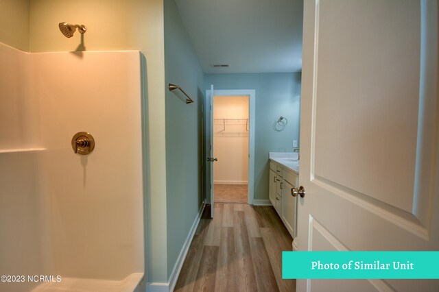 bathroom featuring toilet, vanity, and hardwood / wood-style flooring