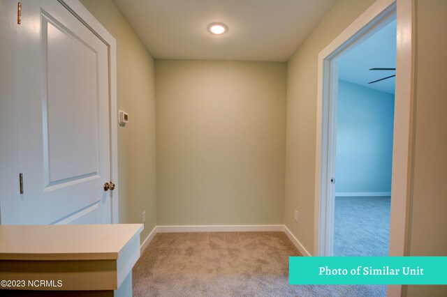 unfurnished room featuring light carpet and ceiling fan