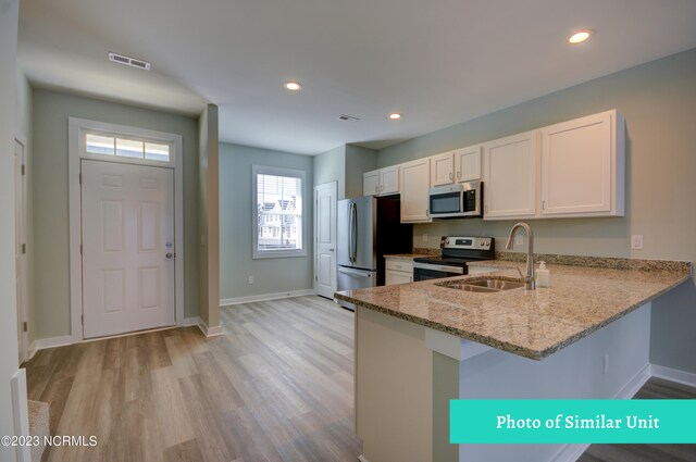 kitchen with stainless steel fridge and dark wood-type flooring