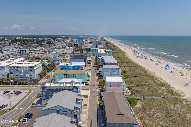 birds eye view of property with a water view and a view of the beach