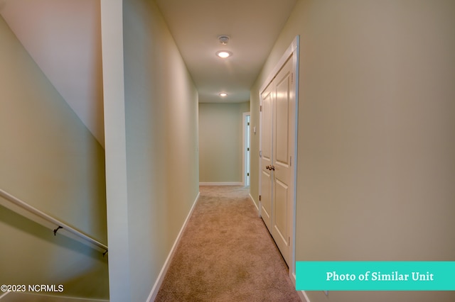 corridor with light colored carpet