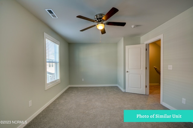 carpeted empty room featuring ceiling fan