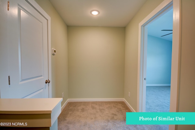 corridor with light colored carpet