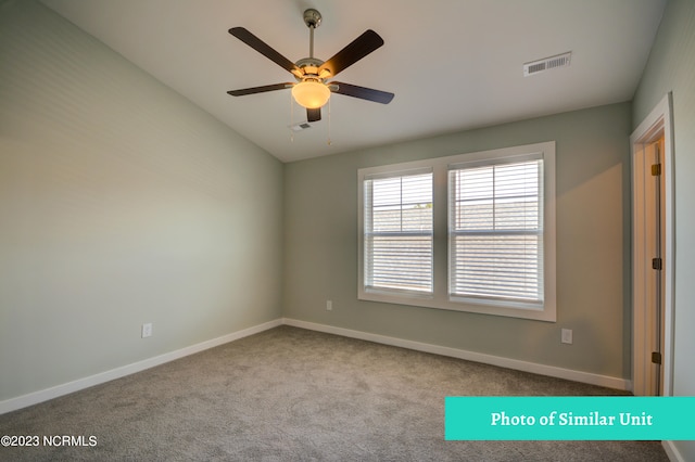 spare room featuring light carpet and ceiling fan