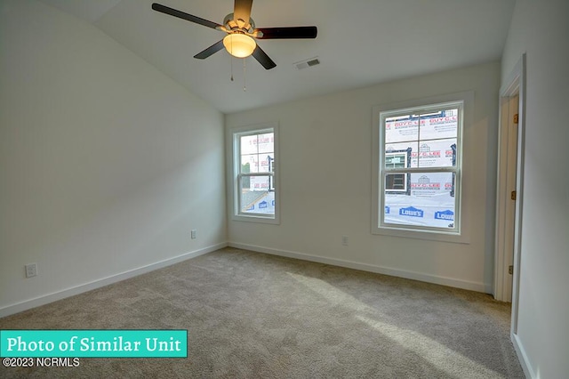 carpeted spare room with ceiling fan and lofted ceiling