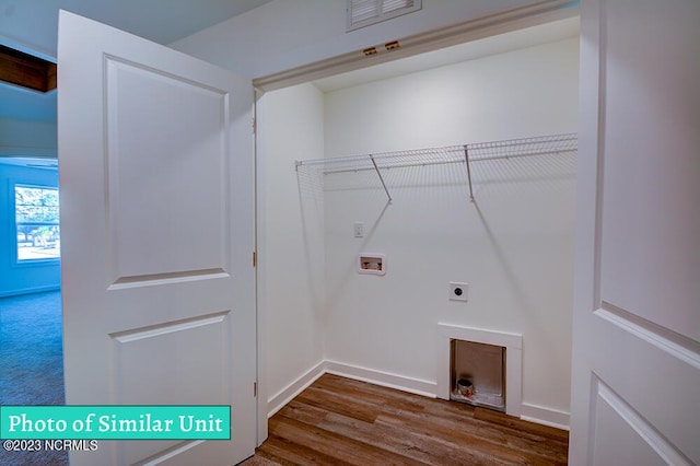 clothes washing area featuring electric dryer hookup, dark wood-type flooring, and hookup for a washing machine