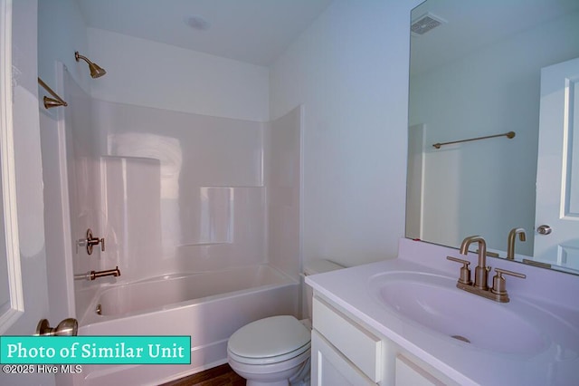 full bathroom with bathing tub / shower combination, vanity, and toilet