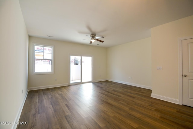 unfurnished room featuring dark wood-type flooring and ceiling fan