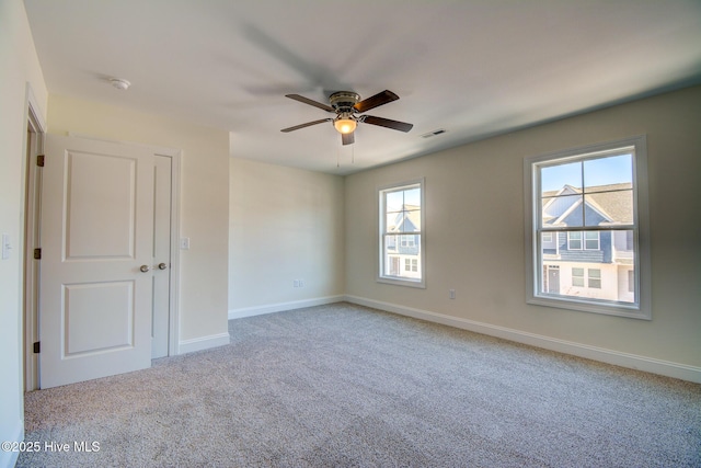 carpeted empty room with ceiling fan