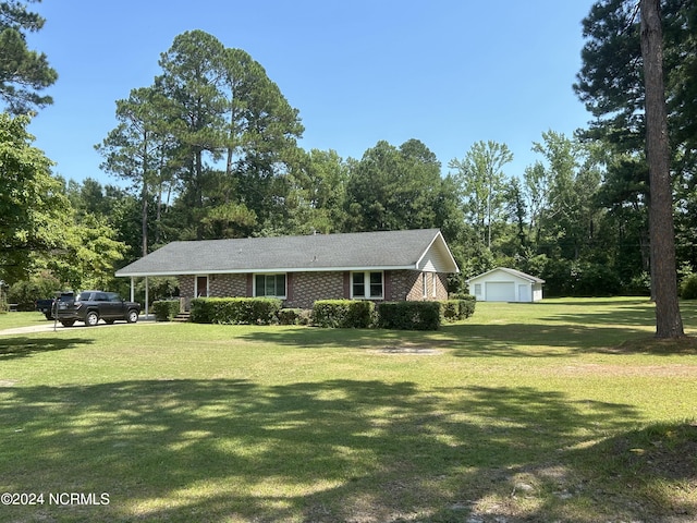 ranch-style home with a garage and a front yard