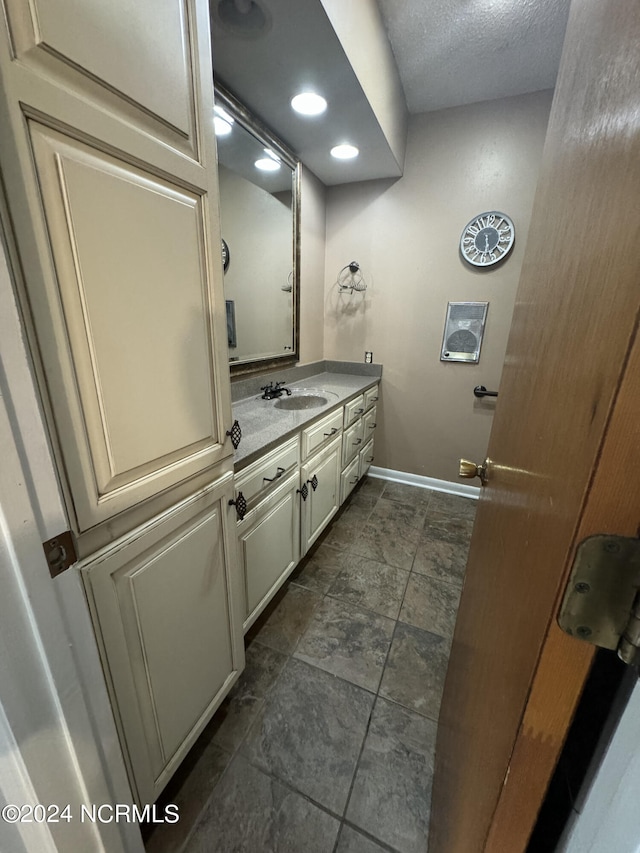 bathroom with tile patterned flooring and vanity