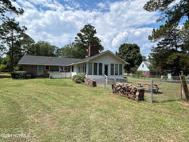 rear view of house with a lawn