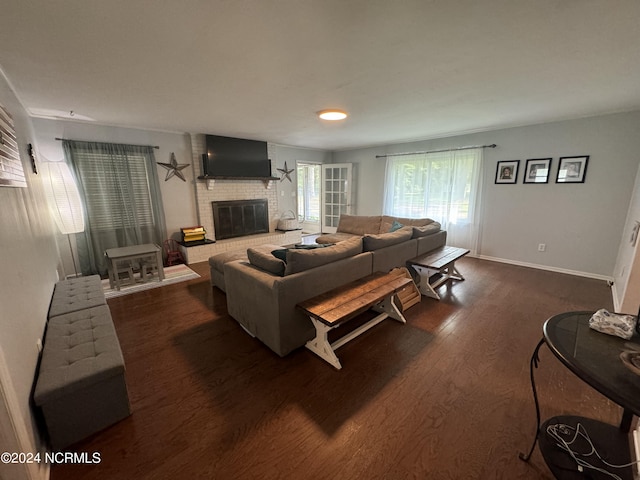 living room with dark hardwood / wood-style floors and a fireplace