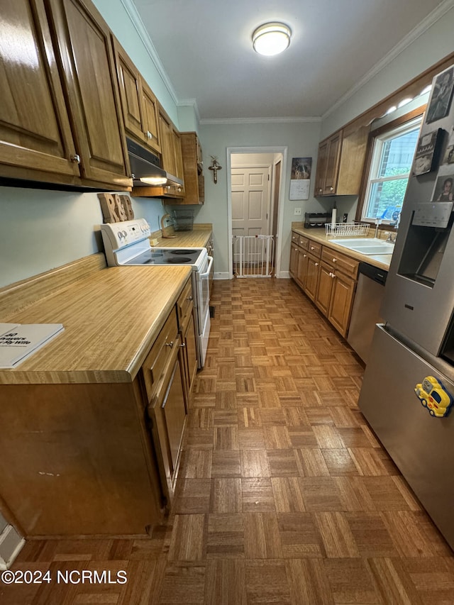 kitchen with stainless steel appliances, parquet flooring, sink, and ornamental molding