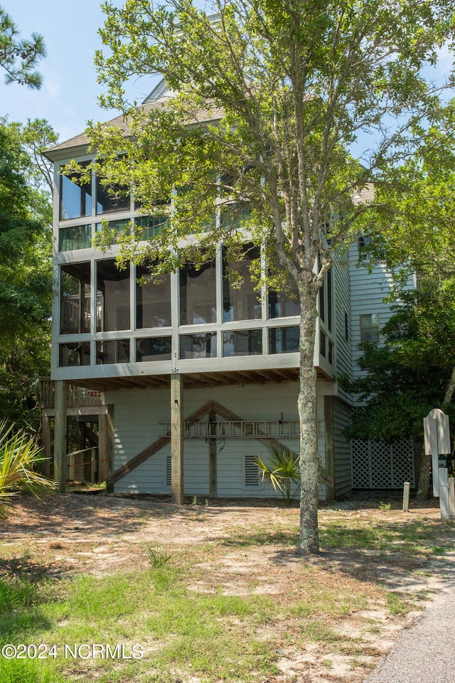 rear view of property with a sunroom