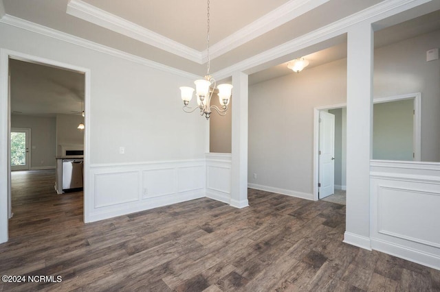 spare room with crown molding, a decorative wall, dark wood-style flooring, and wainscoting