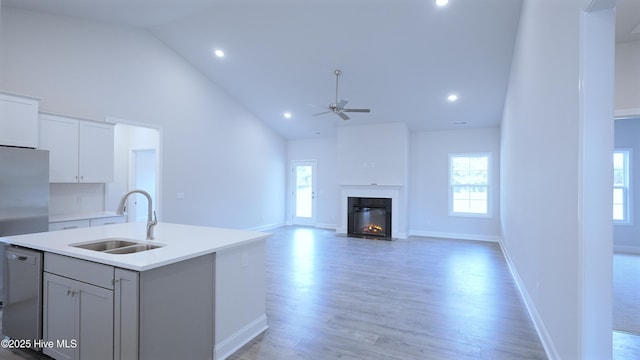 1254 Palatka Pl SE, Bolivia, NC 28422 - kitchen with a sink, high vaulted ceiling, dishwashing machine, a ceiling fan, and an island with sink