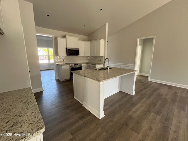 1254 Palatka Pl SE, Bolivia, NC 28422 - kitchen with appliances with stainless steel finishes, a sink, dark wood-style floors, white cabinetry, and light stone countertops