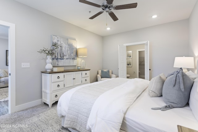 carpeted bedroom with connected bathroom and ceiling fan