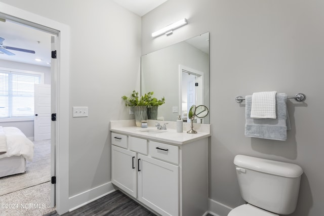 bathroom with vanity, hardwood / wood-style flooring, toilet, and ceiling fan