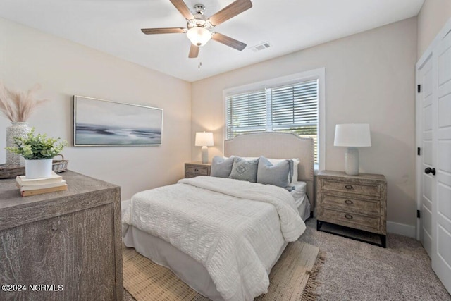 carpeted bedroom with ceiling fan