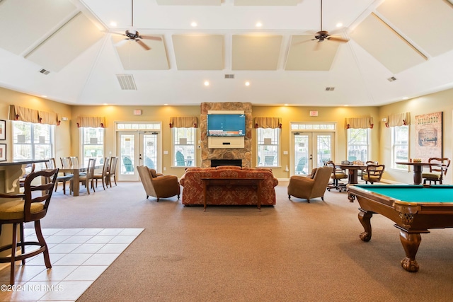 game room featuring light carpet, a fireplace, ceiling fan, and french doors