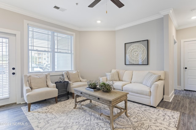 living room with crown molding, light wood-type flooring, and a wealth of natural light