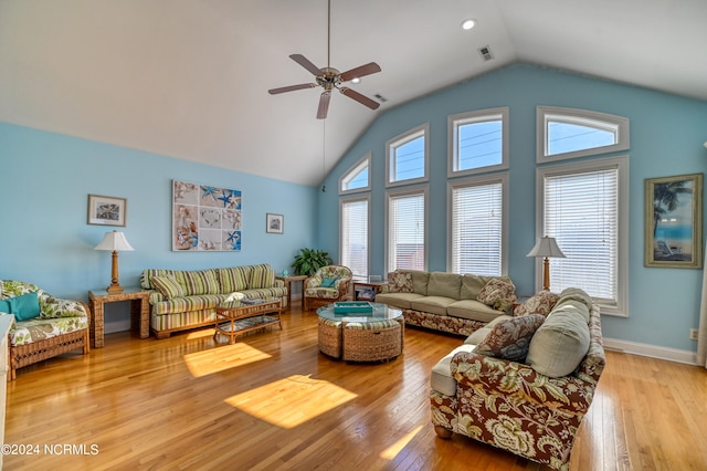 living room with high vaulted ceiling, ceiling fan, and light hardwood / wood-style flooring