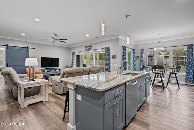 kitchen featuring a healthy amount of sunlight, hardwood / wood-style flooring, and a barn door