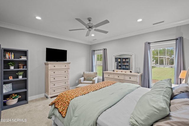 carpeted bedroom featuring ornamental molding and ceiling fan