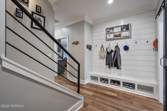 mudroom featuring built in shelves and hardwood / wood-style flooring