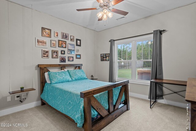 bedroom with light carpet and ceiling fan